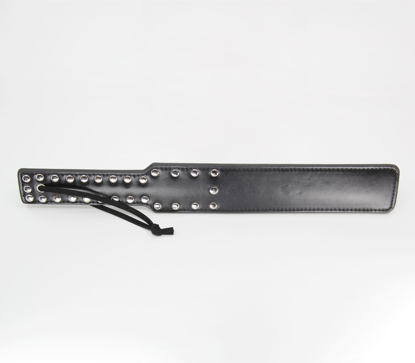 Faux leather paddle with decorative stud handle and wrist strap.